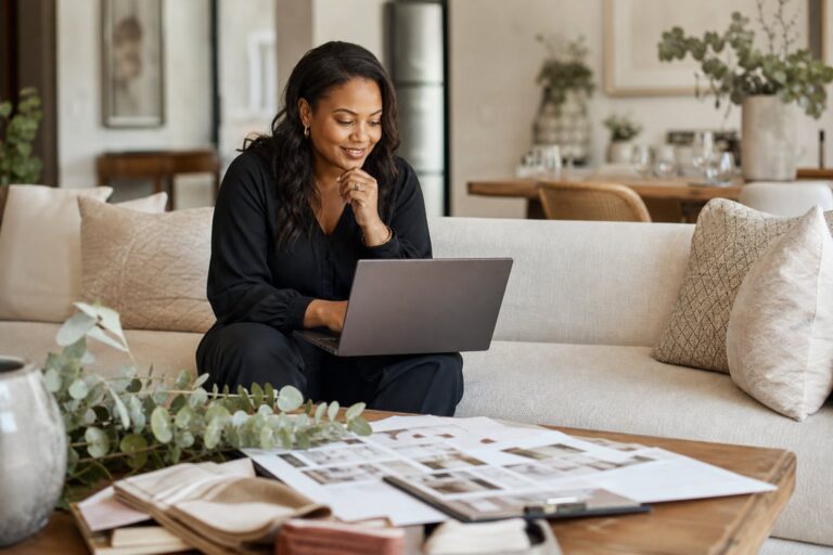 Using AI in a wedding business Wedding stylist using AI tools on a laptop at home