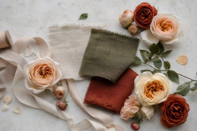 Wedding colour palette of stone olive and rust shown in linen swatches ribbon and fresh flowers