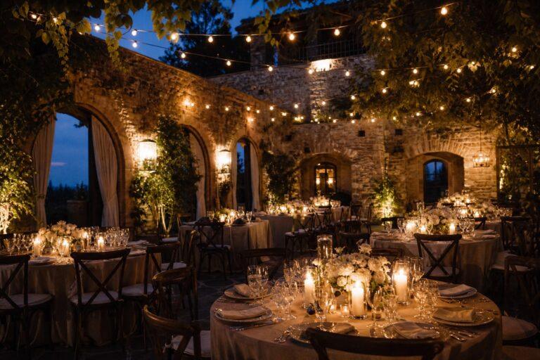 wedding lighting design in a reception room with warm festoon and candlelight